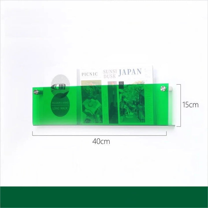 Green acrylic floating shelf, 40cm long and 15cm high, holding magazines.