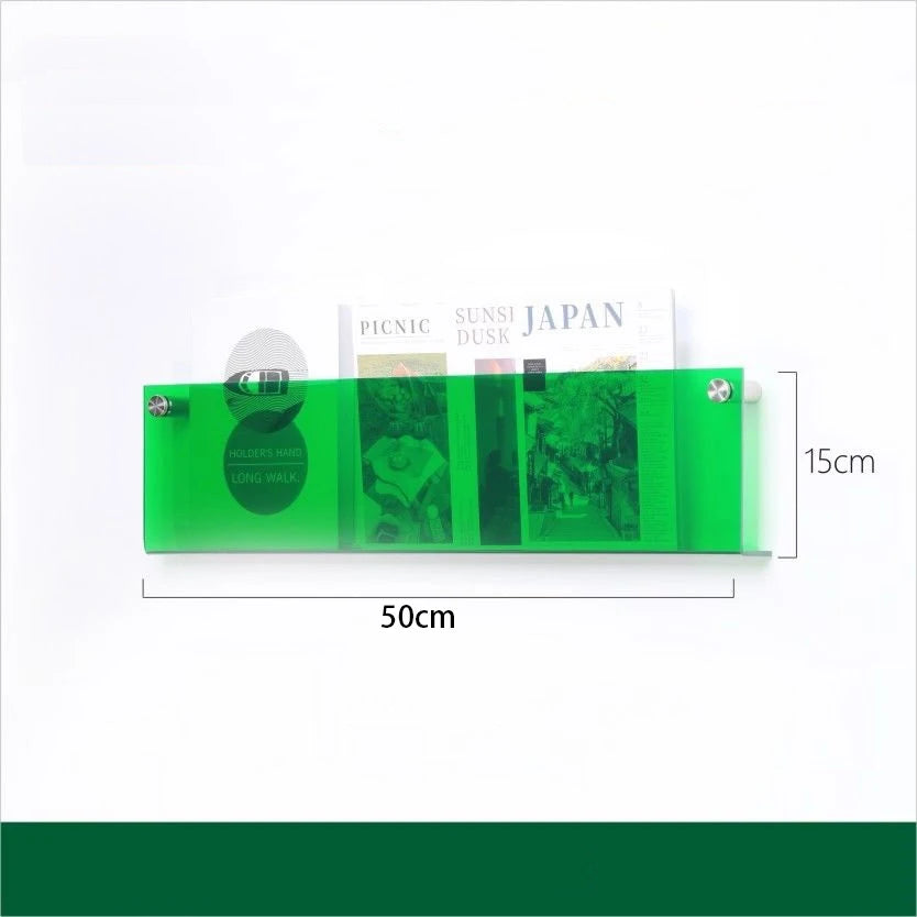A 50cm green acrylic floating shelf holding magazines and books.