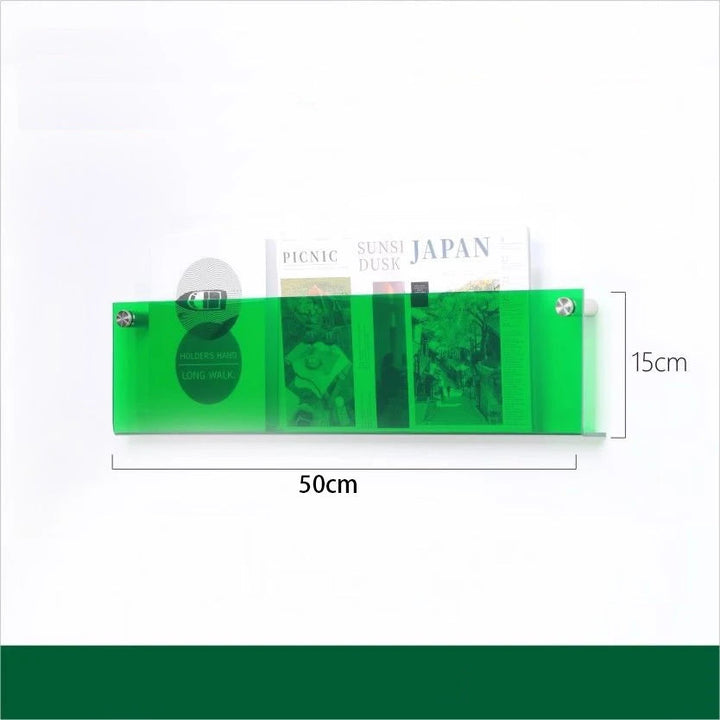 A 50cm green acrylic floating shelf holding magazines and books.