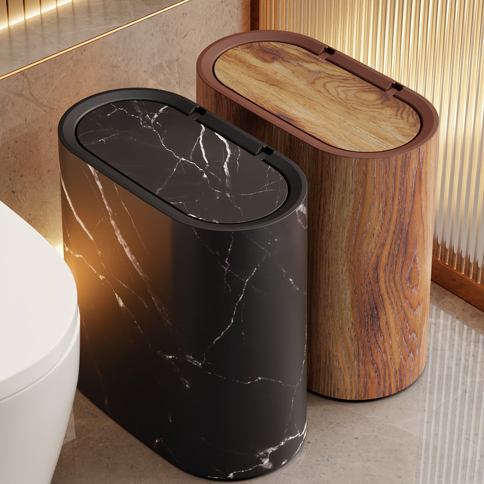 Black marble trash can with oval lid next to a wood-grain trash can with oval lid.