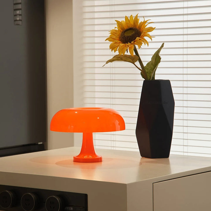 Orange mushroom-shaped LED table lamp with a soft ambient glow.