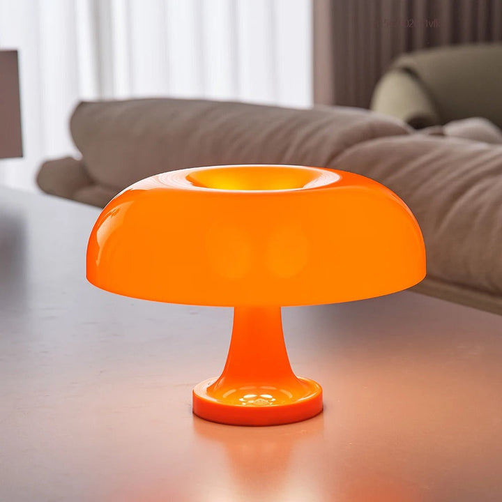 Orange mushroom-shaped LED table lamp with a smooth dome shade and a sculptural base.