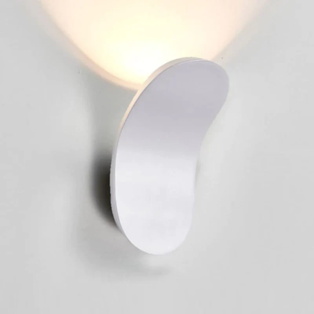 Minimalist white LED wall sconce with a curved design emitting soft light.