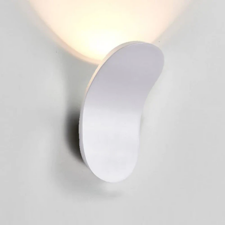 Minimalist white LED wall sconce with a curved design emitting soft light.