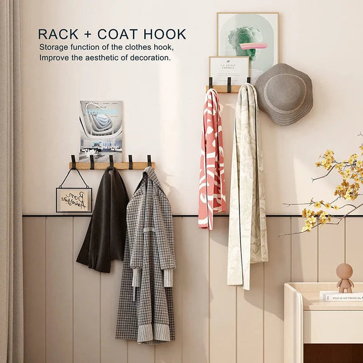Nordic wall coat rack with natural wood finish and black adjustable hooks, holding coats and scarves.