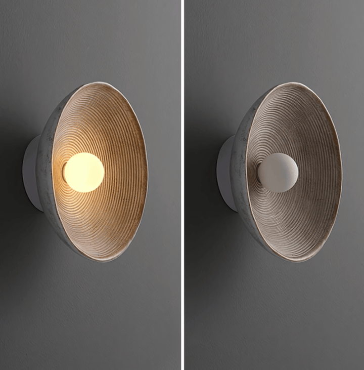Textured wall sconce with concentric ridges, shown lit and unlit.