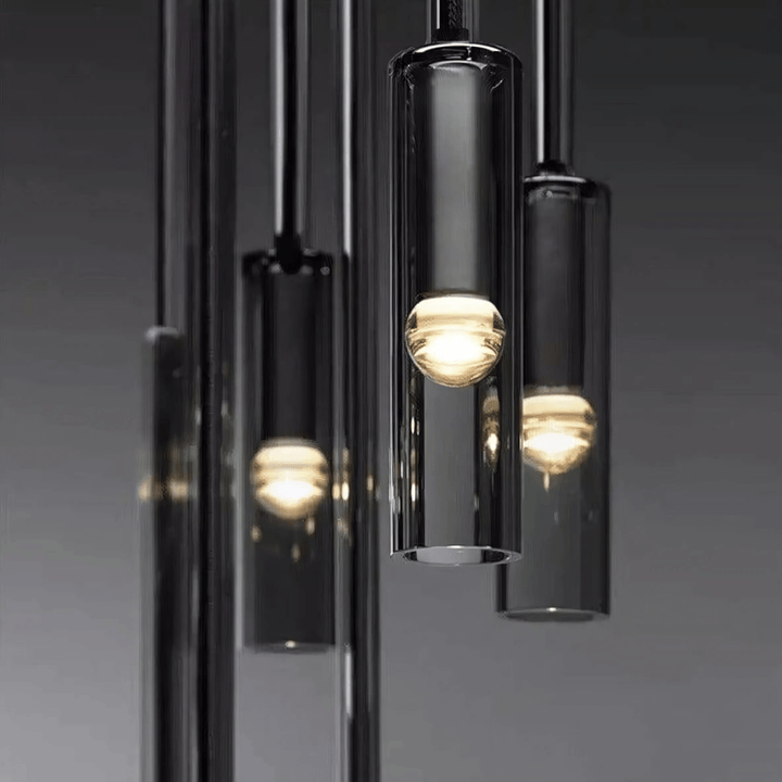Black glass pendant light with internal light source, hanging in a cluster.