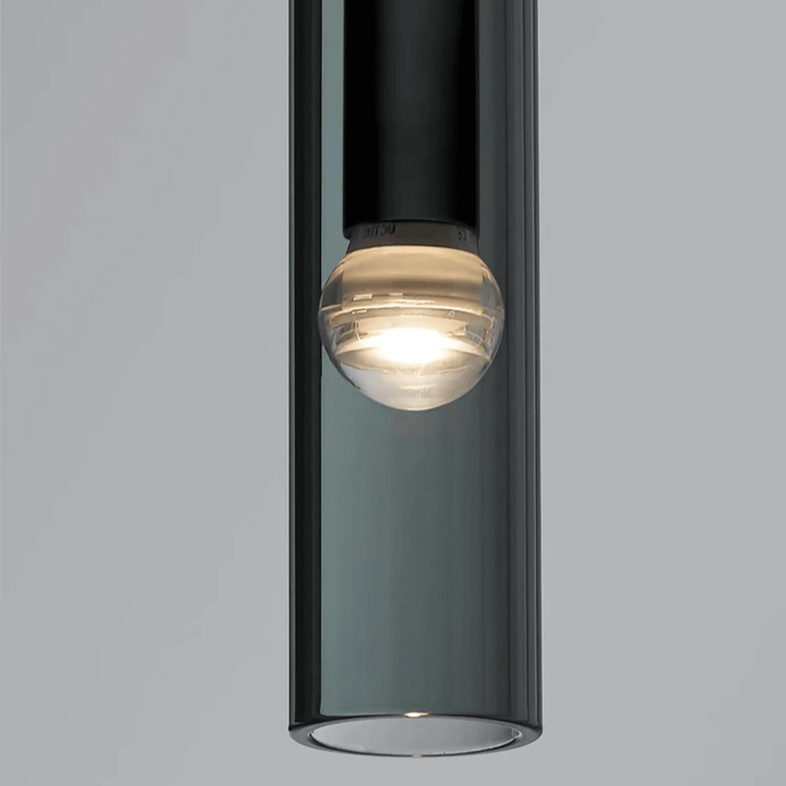 Close-up of a black glass pendant light with a clear glass bulb and visible filament.
