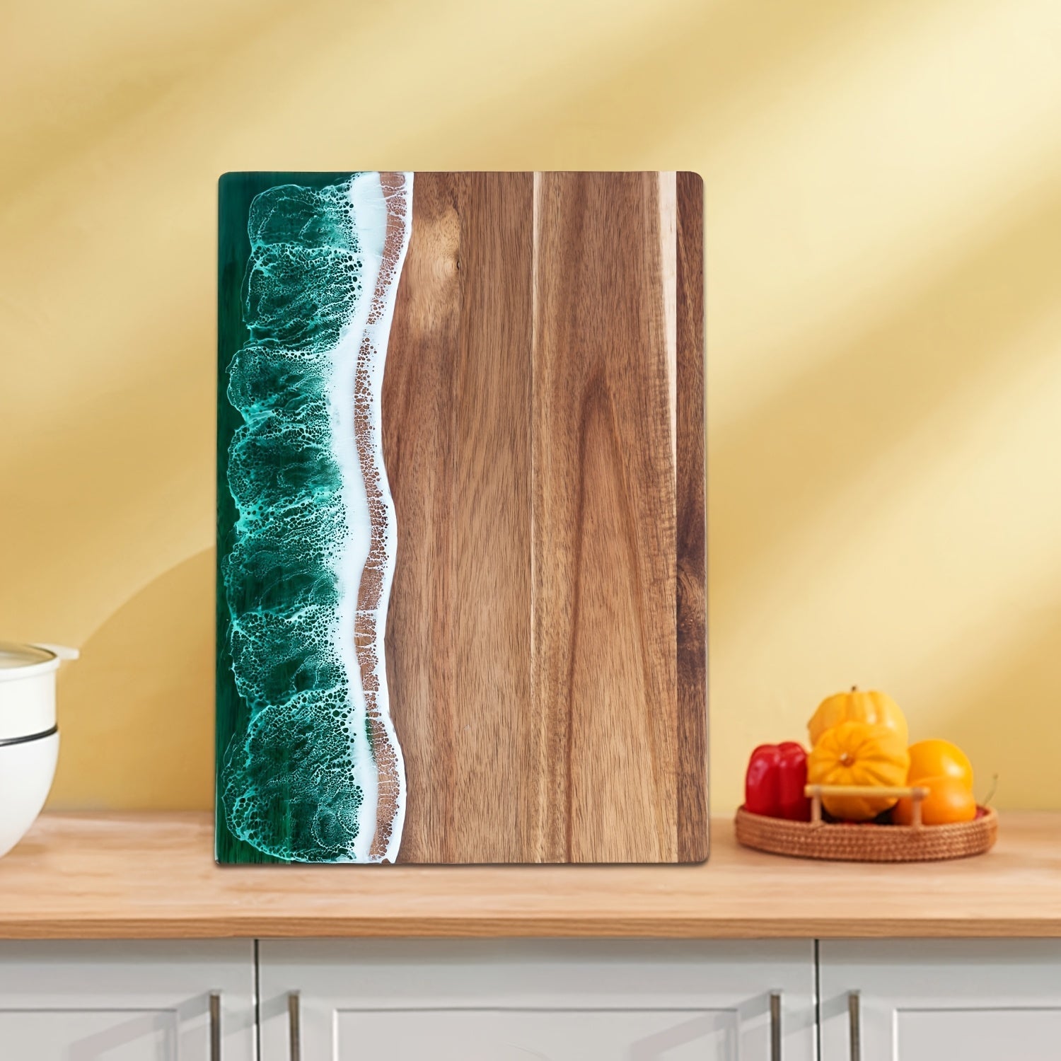 Acacia wood cutting board with a green ocean resin wave design on the left side.