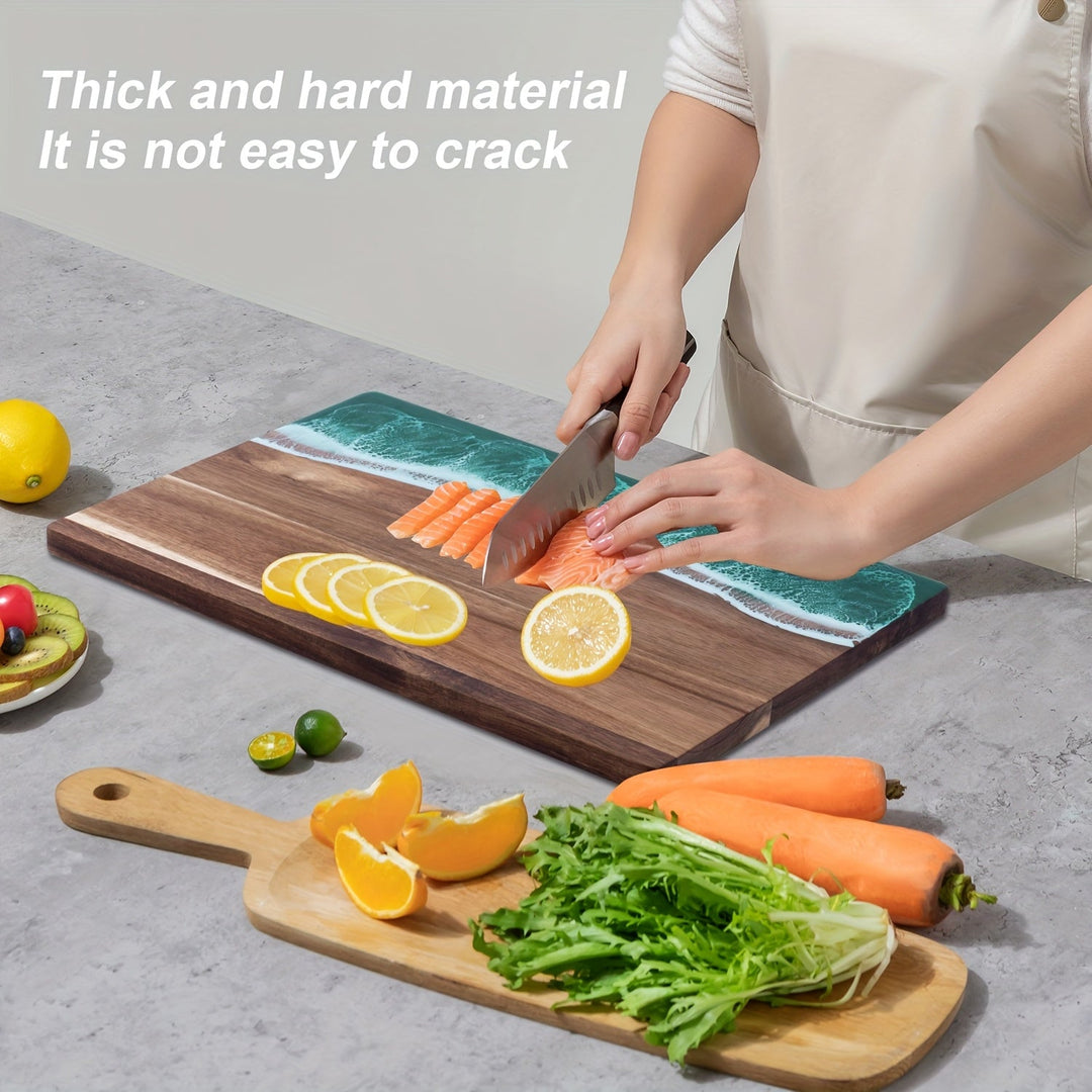 Acacia wood cutting board with a blue ocean resin inlay, featuring sliced salmon, lemons, oranges, carrots, and greens.
