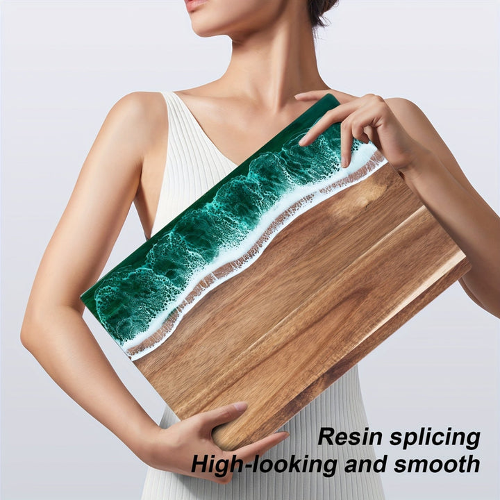 Acacia wood cutting board with a green ocean resin wave design along one edge.