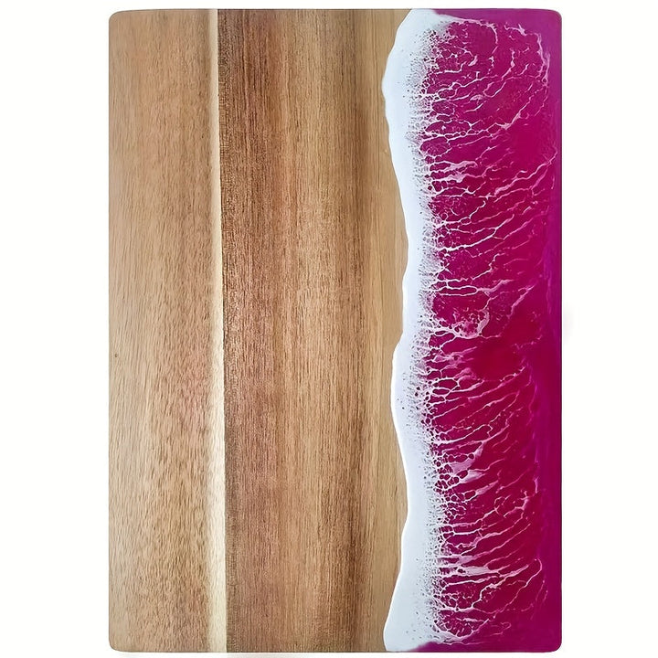 Acacia wood cutting board with a pink and white resin wave design on the right side.
