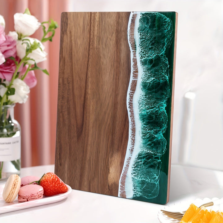 Acacia wood cutting board with a green ocean resin wave design on the right side.