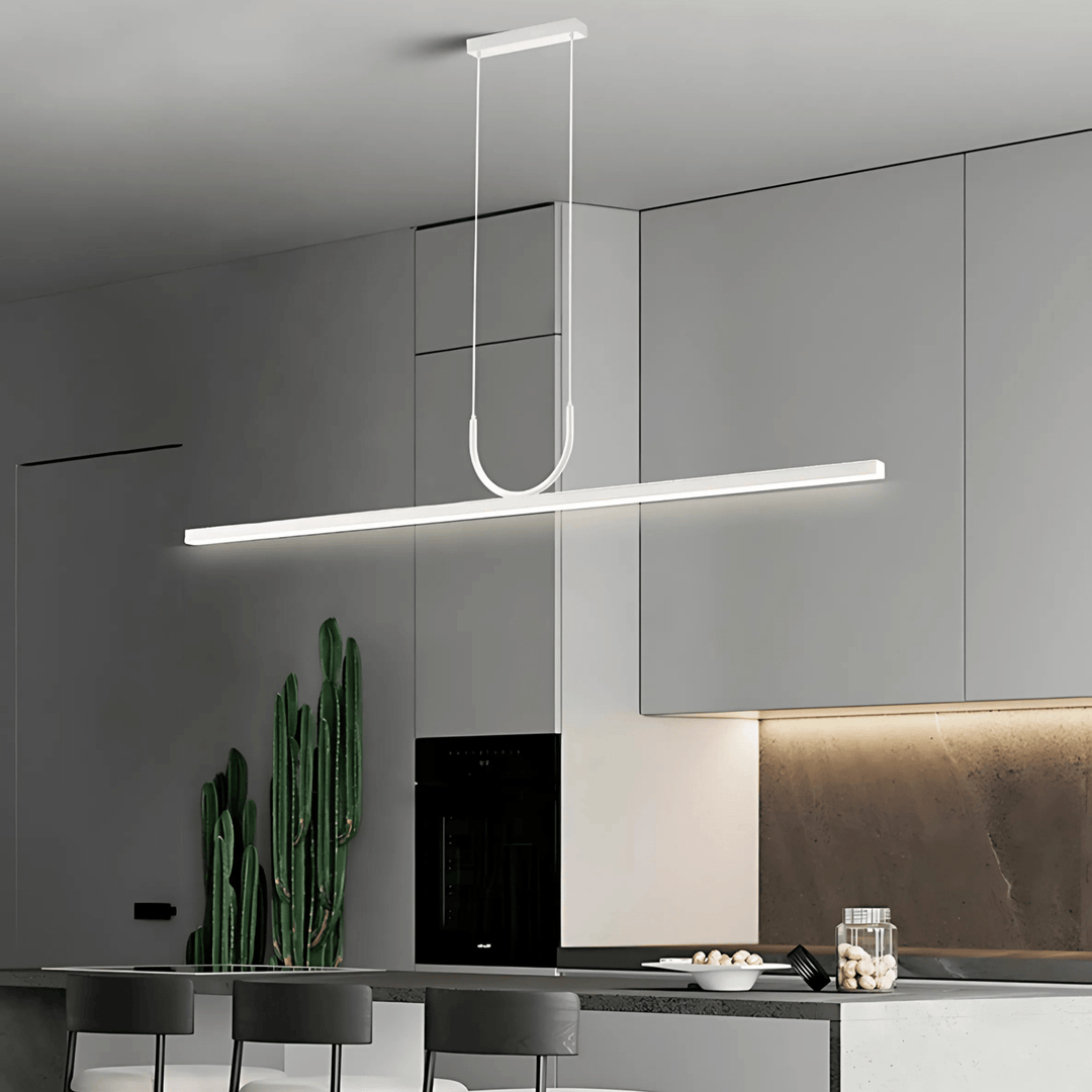 Sleek white pendant light with a U-shaped accent hanging over a modern kitchen island.