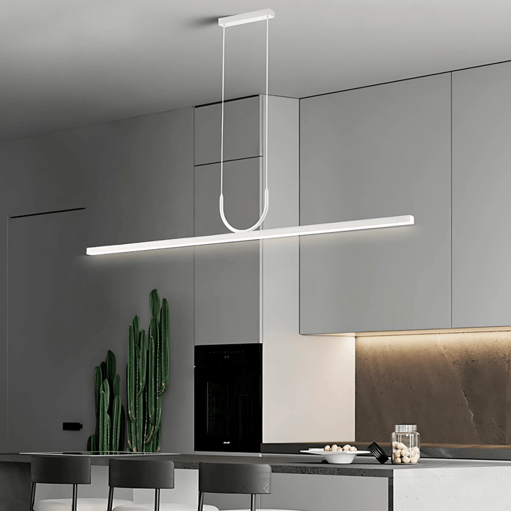 Sleek white pendant light with a U-shaped accent hanging over a modern kitchen island.