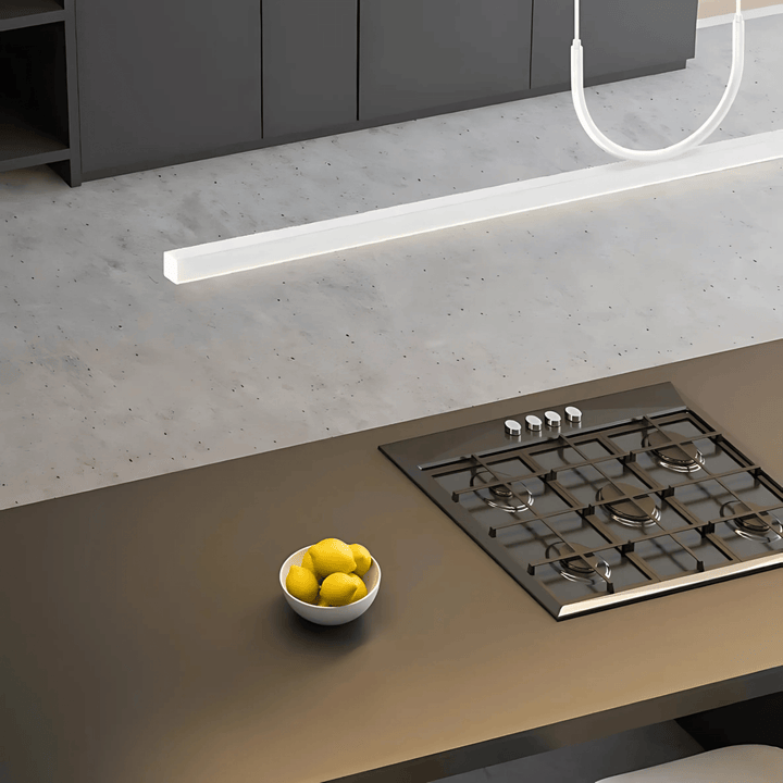 Sleek pendant light with a modern, rectangular design over a kitchen island.