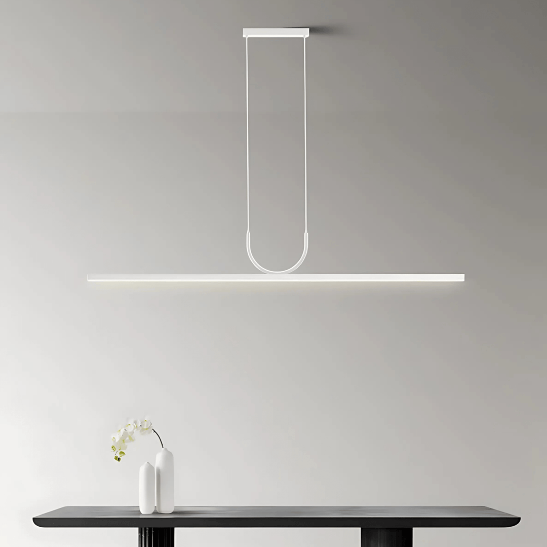 White sleek pendant light with a long rectangular bar suspended by two thin cords.