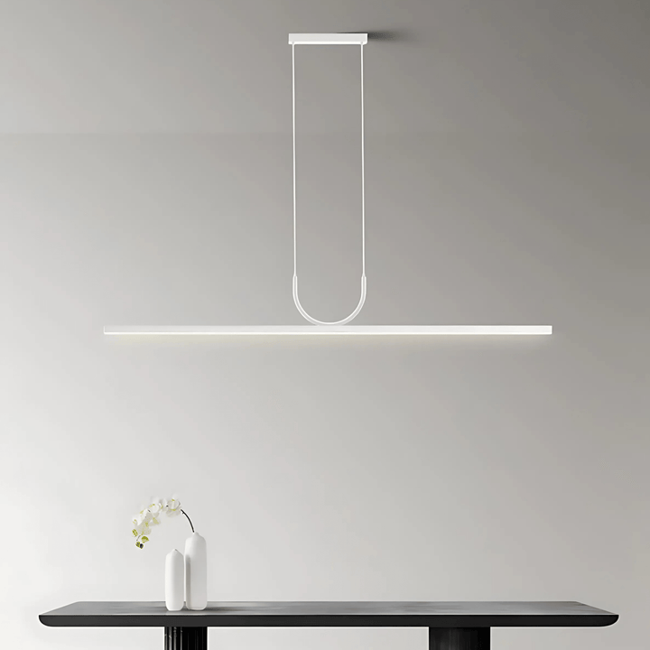 White sleek pendant light with a long rectangular bar suspended by two thin cords.