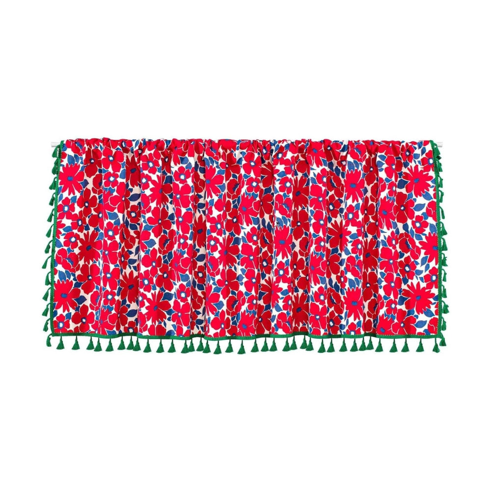 Red floral cabinet curtain with green tassels on the bottom and sides.