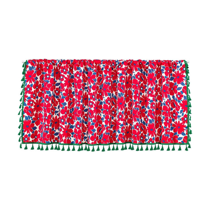 Red floral cabinet curtain with green tassels on the bottom and sides.