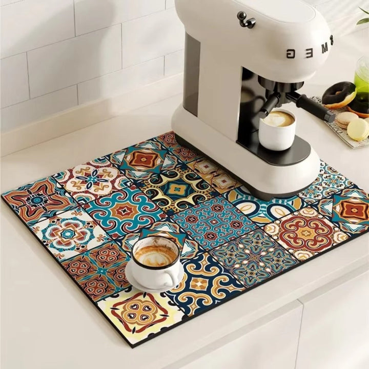 Retro tile absorbent coffee mat under a coffee machine and cup.