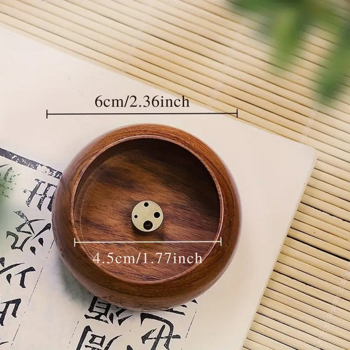 Round solid wood incense holder with a brass insert featuring multiple holes. Dimensions shown are 6cm/2.36 inches and 4.5cm/1.77 inches.
