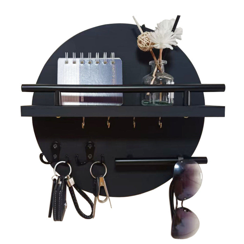 Black round wooden key holder with shelf, hooks, keys, sunglasses, and decorative items.