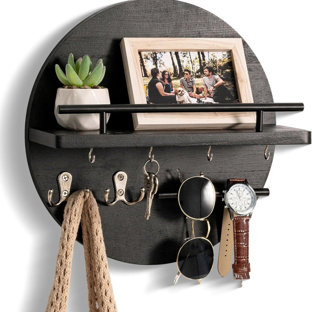 Round wooden key holder with shelf, hooks, photo frame, plant, sunglasses, watch, and scarf.