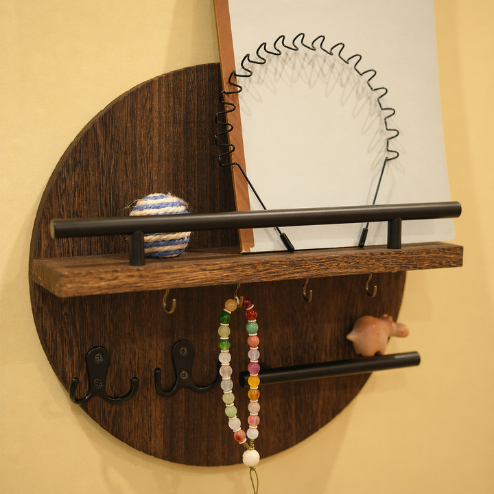 Round wooden key holder with a shelf, hooks, and decorative items.