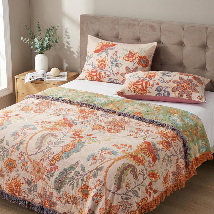 Two rustic floral boho pillowcases on a bed with a matching blanket.