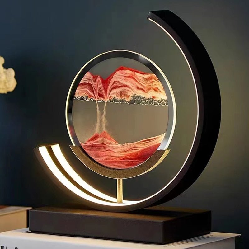 Modern desk lamp with a circular glass frame showing red sand art and a curved LED light.