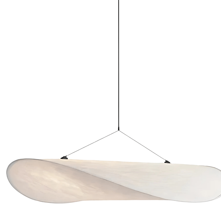 Minimalist pendant light with a white, sail-shaped shade suspended by thin wires.