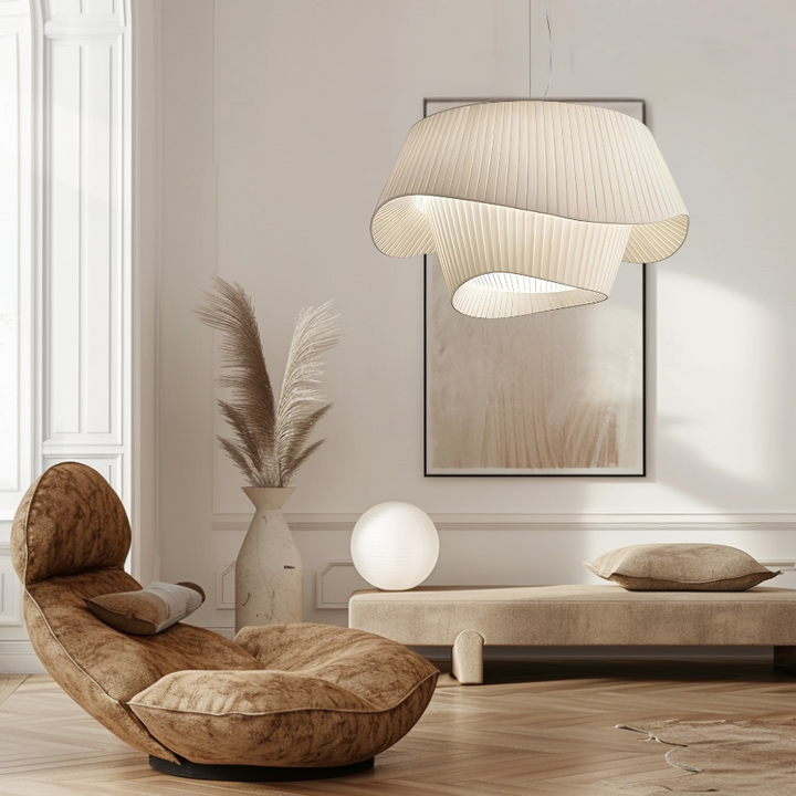 White acrylic pendant light with a sail shape hanging in a modern living room.