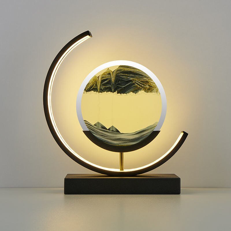Modern black desk lamp with a circular sand art display and warm LED light.