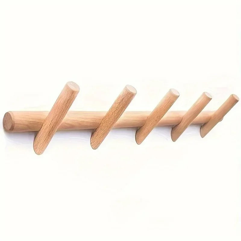 Solid oak wall coat rack with five angled pegs on a white background.
