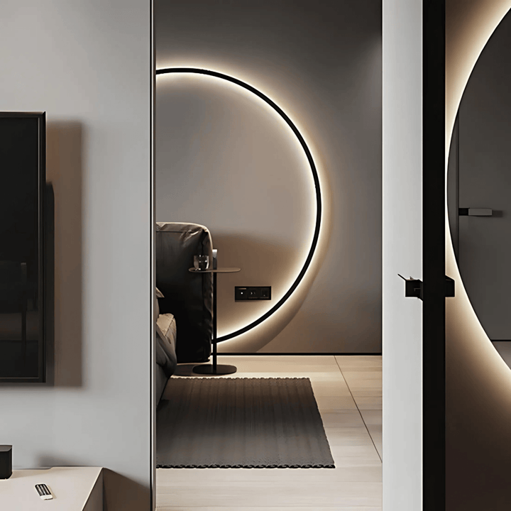 Modern circular wall sconce with adjustable ambient lighting in a bedroom.