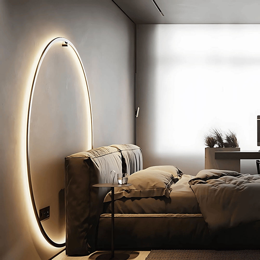 Modern oval wall sconce with dimmable ambient lighting in a bedroom.