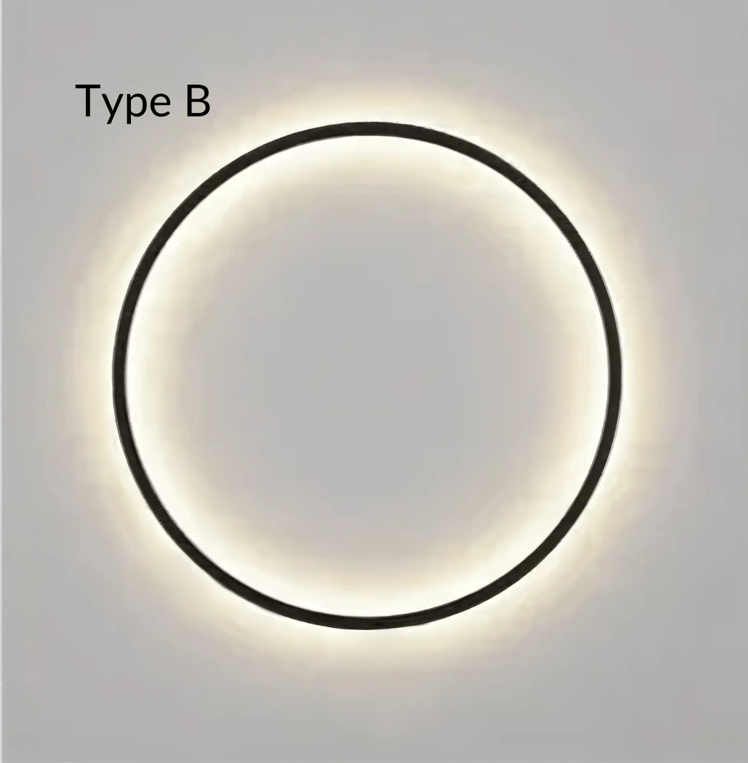 Type B modern circular wall sconce with a black frame and warm ambient light.
