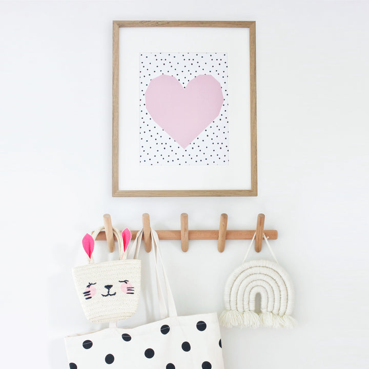 Beechwood wall coat rack with 5 hooks, holding a bunny bag, a tote bag, and a macrame rainbow.