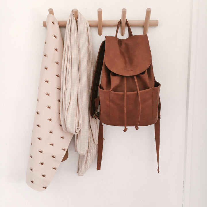 Beechwood wall coat rack with 5 hooks, holding a brown backpack and a striped scarf.