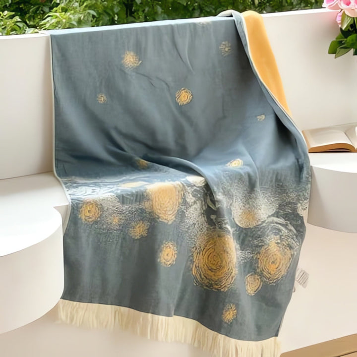 Blue cotton bath towel with a yellow and white starry night pattern and fringe trim.