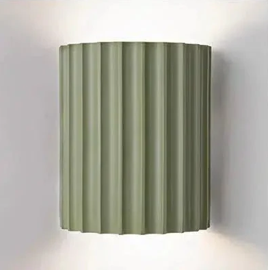 Sage green fluted wall sconce with integrated LED lighting.