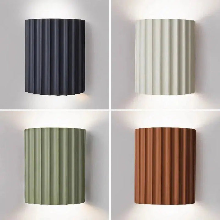 Four contemporary LED wall sconces in dark gray, off-white, sage green, and terracotta.