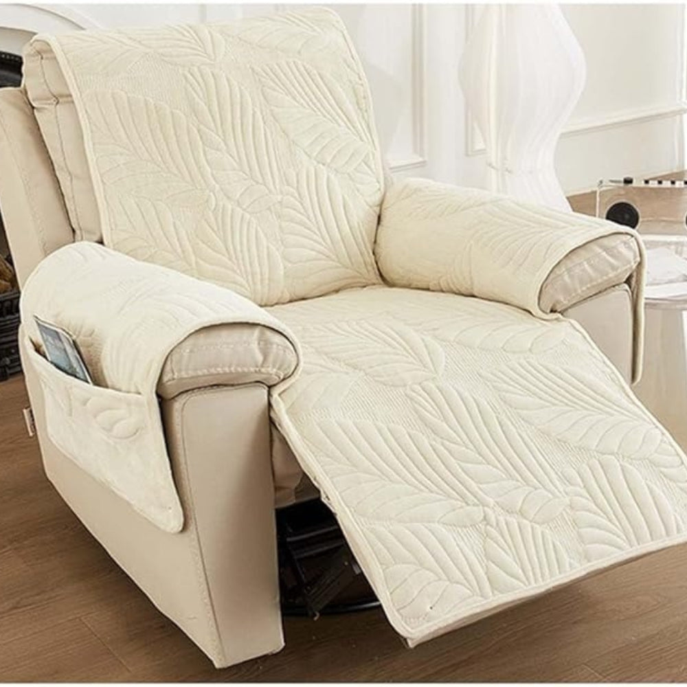 Cream recliner chair cover with a quilted leaf pattern and side pockets.