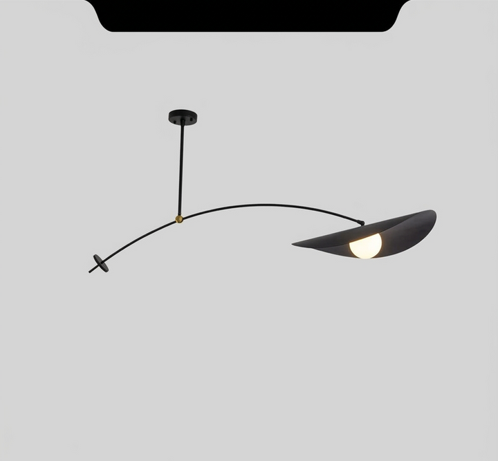 Black adjustable pendant light with a curved arm and a leaf-shaped shade housing a light bulb.