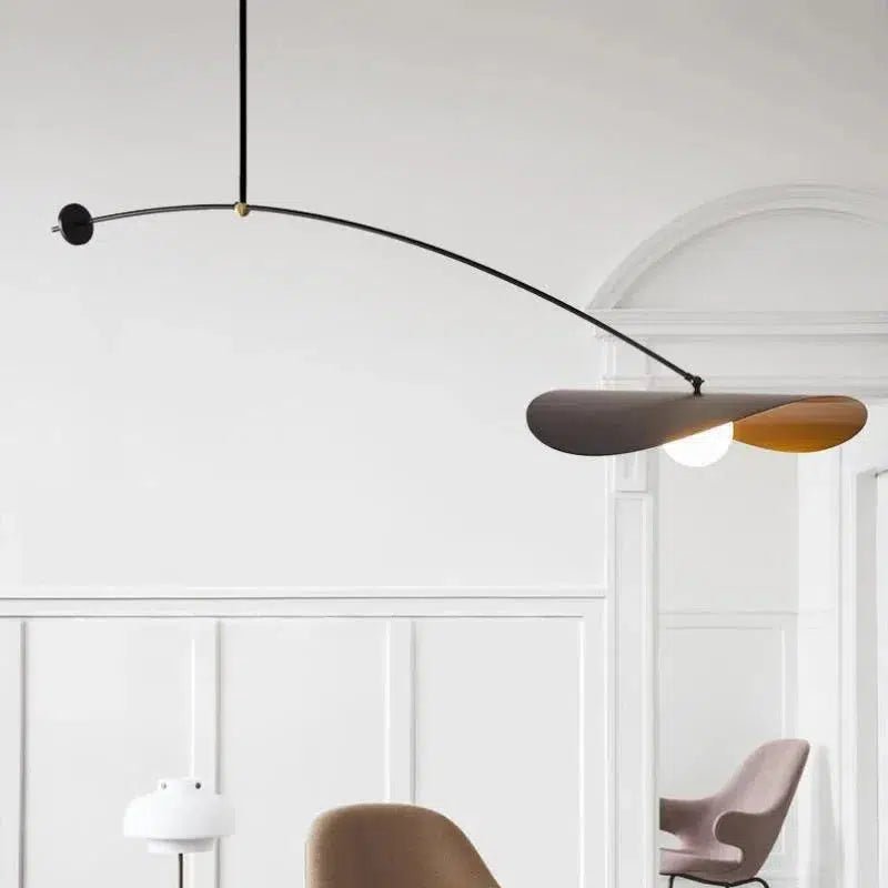Black adjustable pendant light with a curved arm and a wide, dark shade over a light bulb.