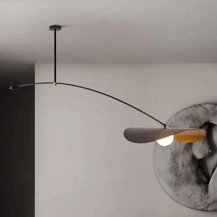 Black adjustable pendant light with a curved arm and a leaf-shaped shade with a light bulb.