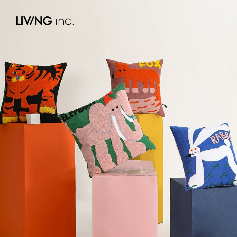 Four decorative throw pillows with animal designs: a tiger, a fox, an elephant, and a rabbit.