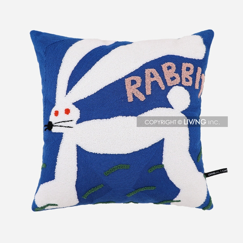 Blue throw pillow with a white rabbit design and the word RABBIT in pink letters.