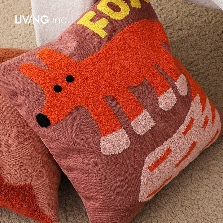 Brown throw pillow with a textured orange fox design and yellow lettering.